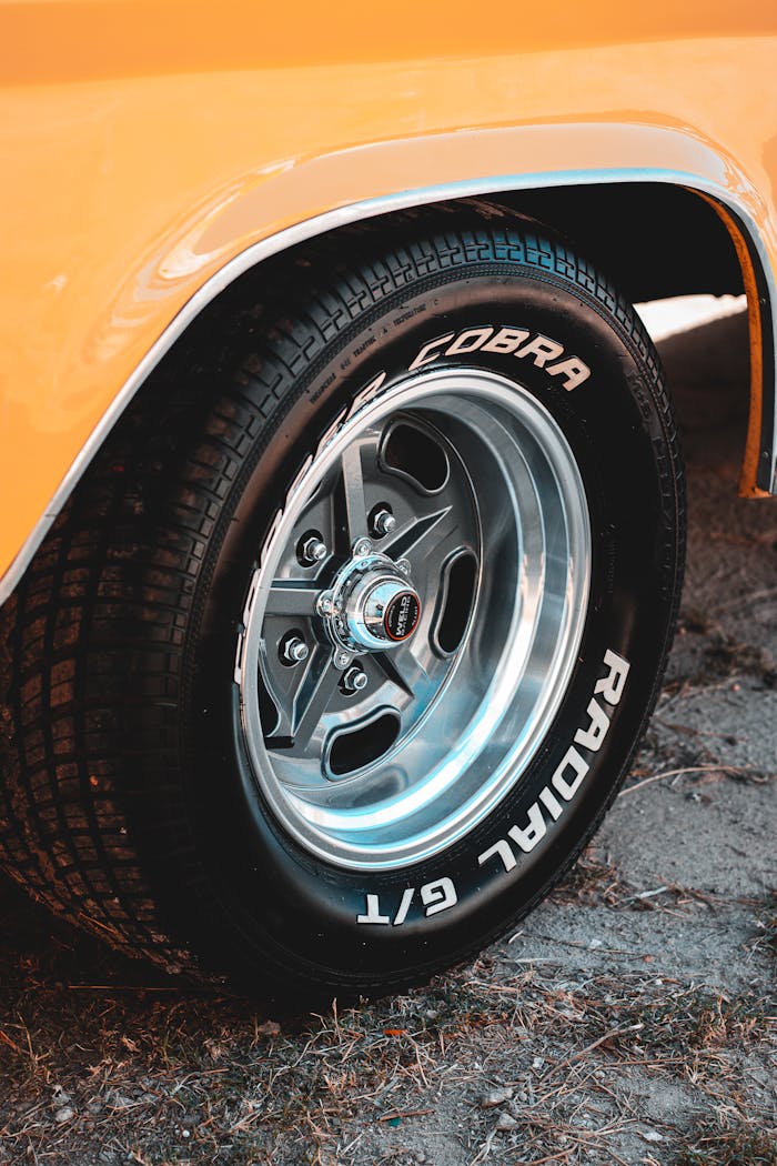 Detailed view of a classic muscle car tire showcasing the steel rim and branded wheel design.